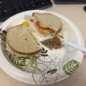 Wawa - tuna sandwich on rye with some type of paper in sandwich